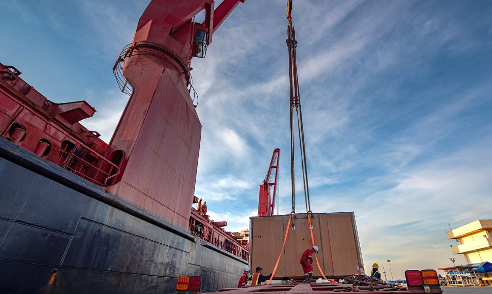 Package unit of the heavy life cargo being discharging or loading by the ship crane under supervisor by professional handling in the port terminal