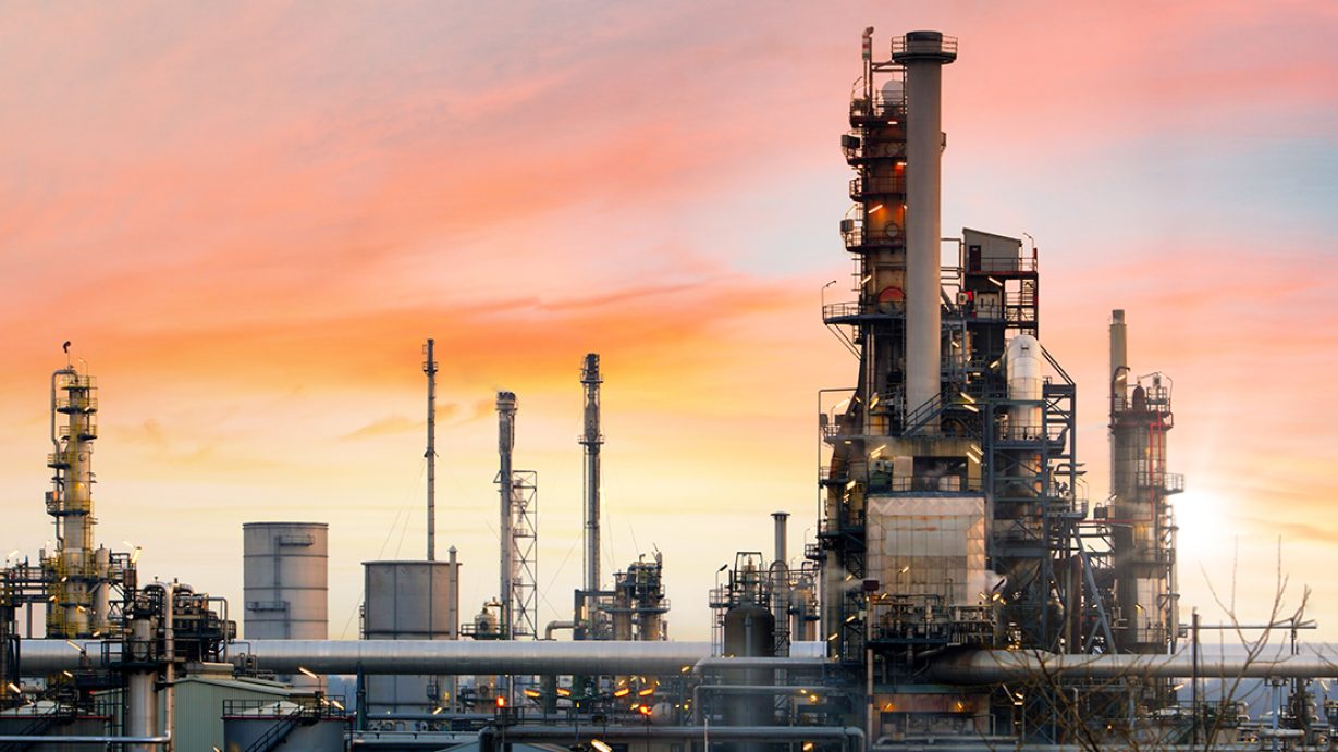 Oil refinery and plant and tower column of Petrochemistry industry in oil and gas industrial with cloud orange sky the sunrise background