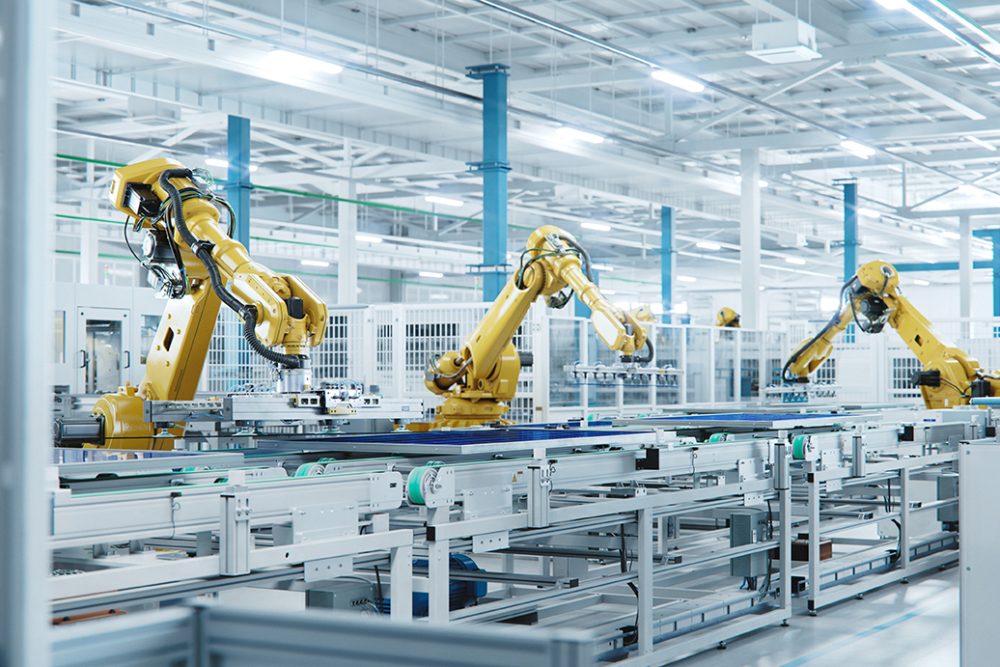 Large Production Line with Industrial Robot Arms at Modern Bright Factory. Solar Panels are being Assembled on Conveyor. Automated Manufacturing Facility